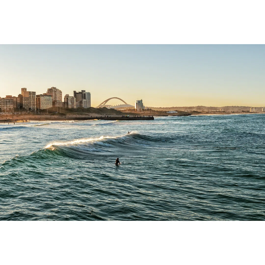 Surfers Enjoying The Waves During Sunset